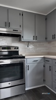 131 Ruth Street Bridgeport, CT 06606 - Photo 20 of 31 a kitchen with stainless steel appliances granite countertop a stove and a microwave
