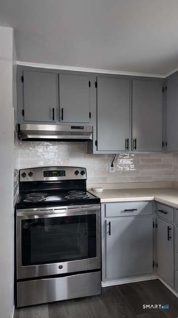 131 Ruth Street Bridgeport, CT 06606 - Photo 21 of 31 a stove top oven sitting inside of a kitchen