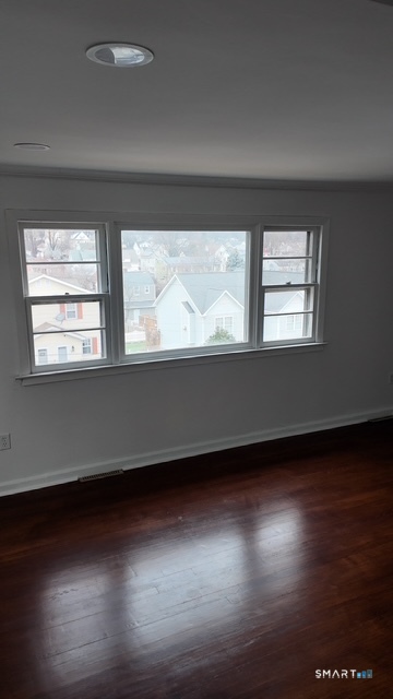 131 Ruth Street Bridgeport, CT 06606 - Photo 24 of 31 a view of an empty room with wooden floor and a window