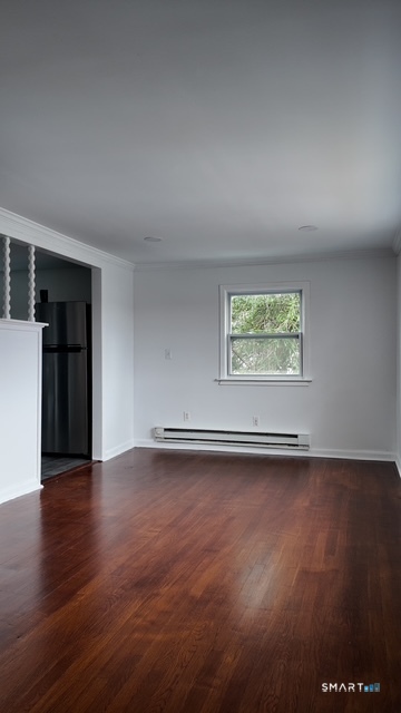 131 Ruth Street Bridgeport, CT 06606 - Photo 26 of 31 an empty room with wooden floor and windows