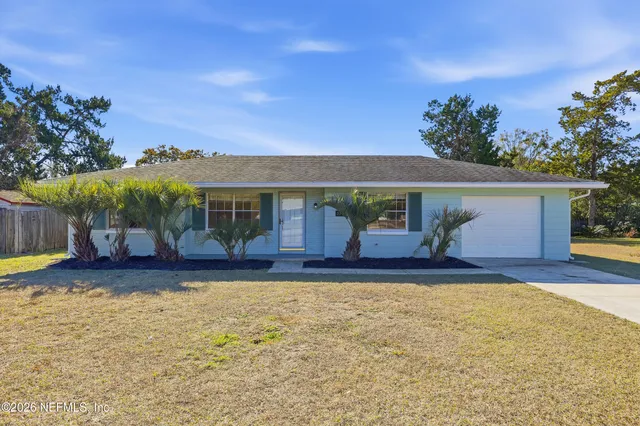 a view of a house with garden and yard