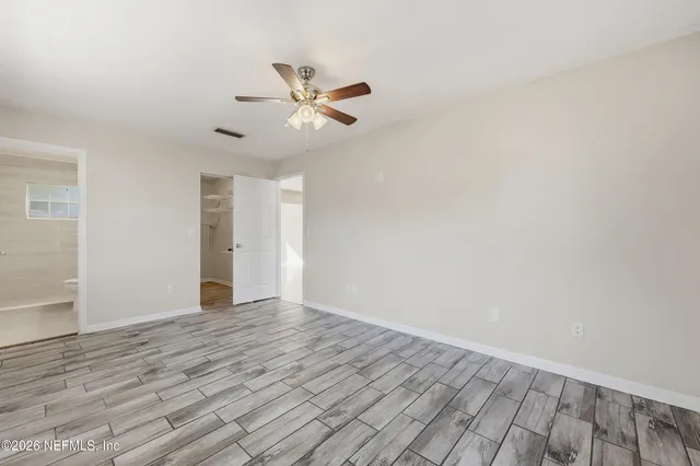 a view of an empty room and wooden floor
