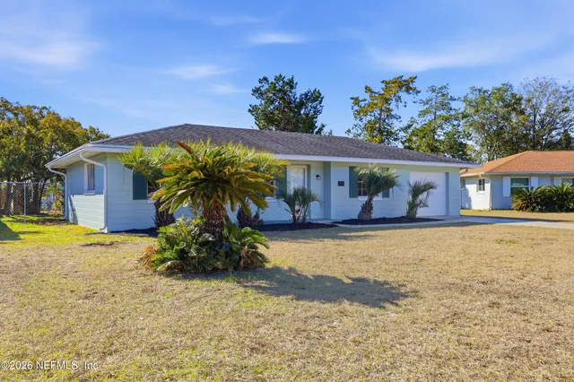 a vase of flowers sitting in front of a house