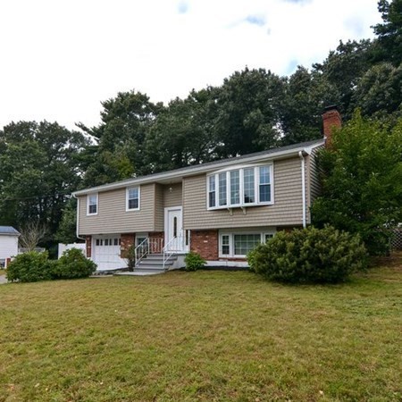 9 Jeffrey Road Canton, MA 02021 - Photo 1 of 38 a front view of a house with garden and trees