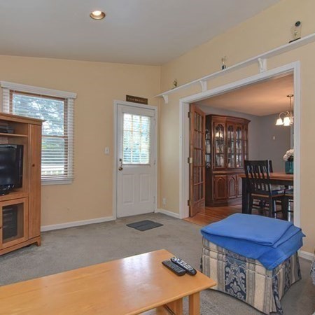 9 Jeffrey Road Canton, MA 02021 - Photo 13 of 38 a living room with a table chairs and a fireplace