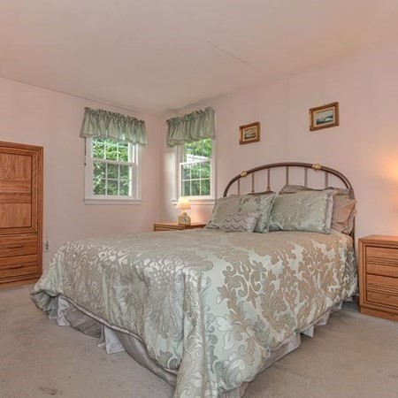9 Jeffrey Road Canton, MA 02021 - Photo 14 of 38 a bed sitting in a bedroom next to a window