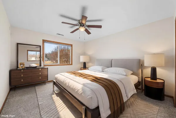 a bedroom with a large bed and a window
