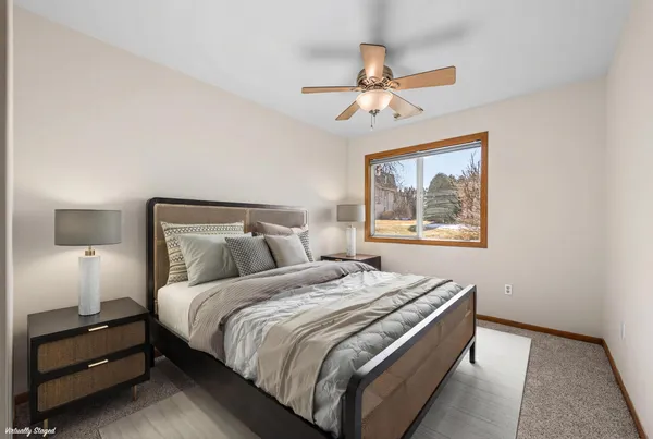 a bedroom with a bed and a painting on the wall