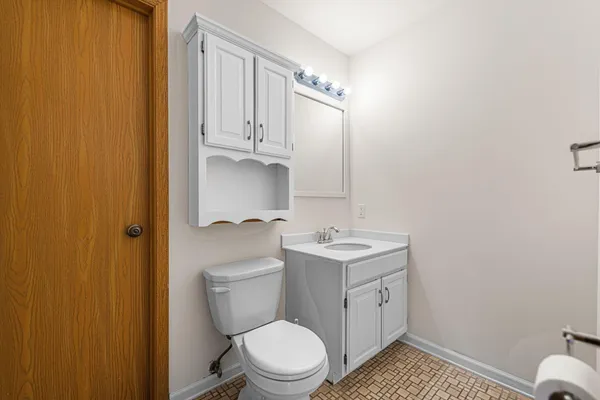 a bathroom with a toilet a sink and a mirror