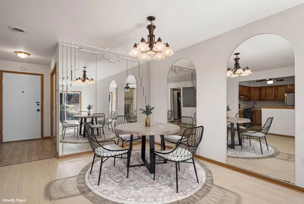 a view of a dining room with furniture and chandelier