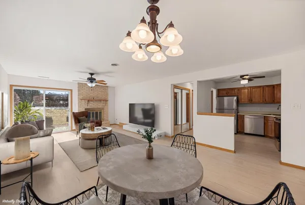 a livingroom with kitchen island furniture and a chandelier