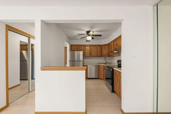 a view of a kitchen with a sink and a refrigerator
