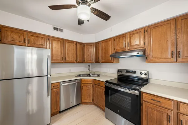 a kitchen with a sink stainless steel appliances and cabinets