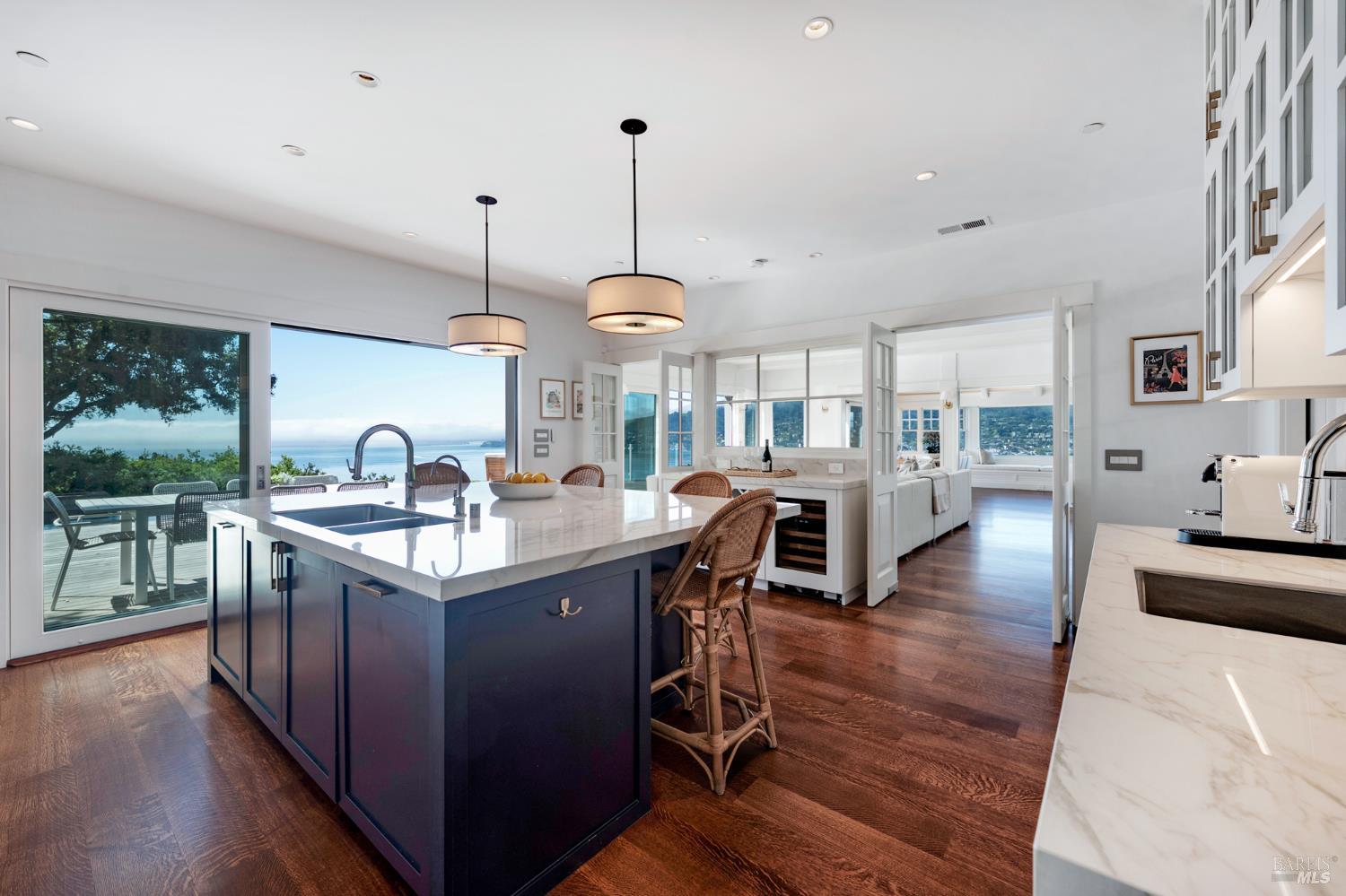 22 Eucalyptus Road Belvedere, CA 94920 - Photo 21 of 64 a kitchen with stainless steel appliances granite countertop a sink a stove and a wooden floors