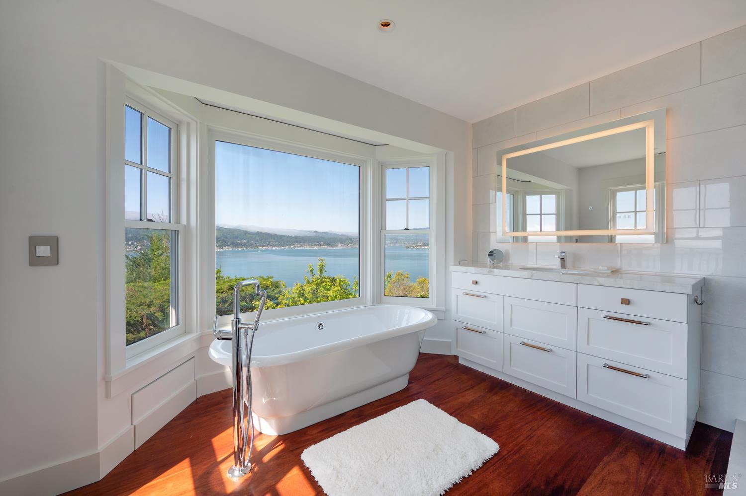 22 Eucalyptus Road Belvedere, CA 94920 - Photo 28 of 64 a room with a bed and large windows