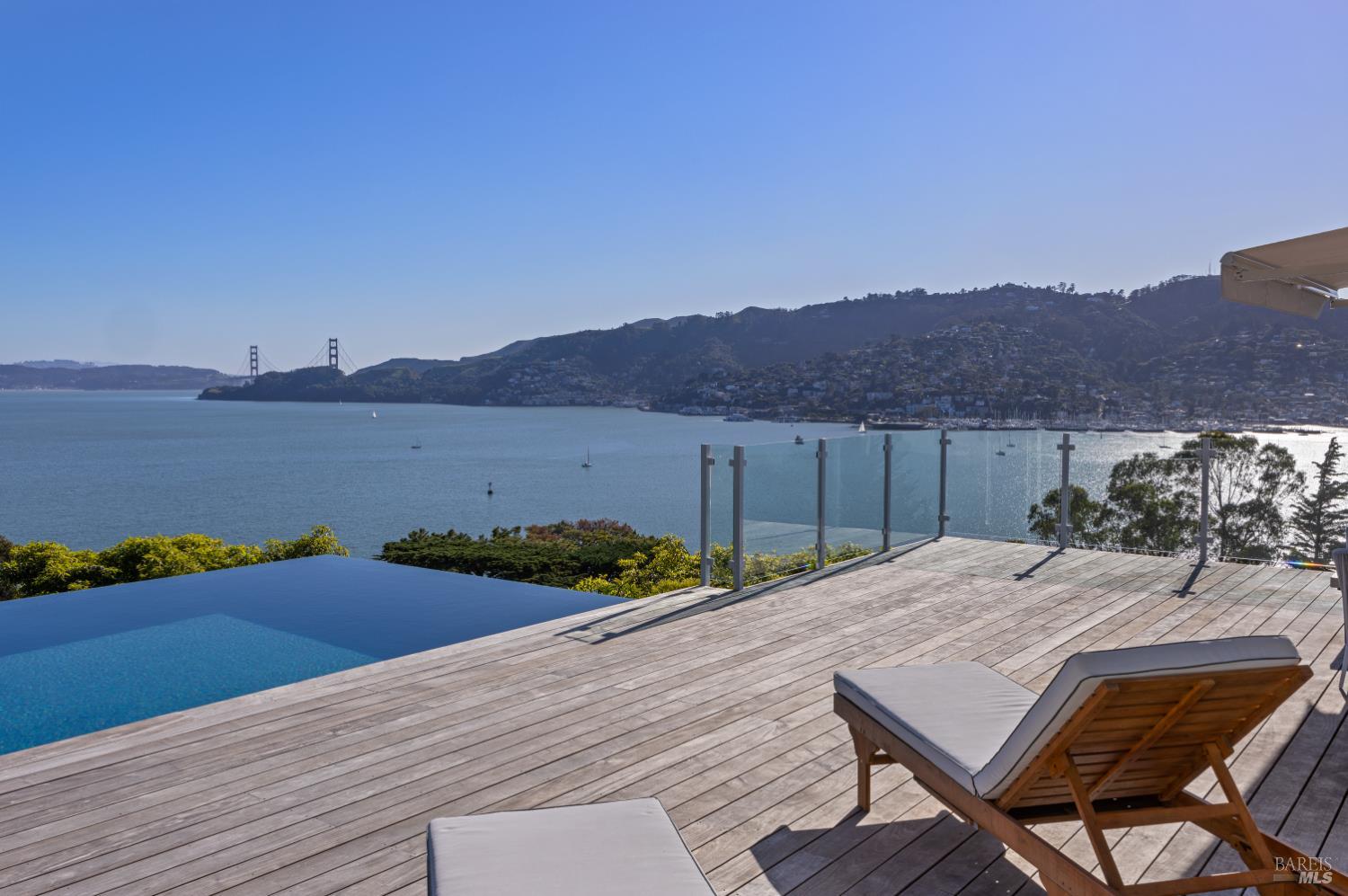 22 Eucalyptus Road Belvedere, CA 94920 - Photo 53 of 64 a view of a terrace with a table and chairs under an umbrella