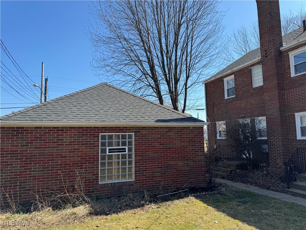 3721 4th Street Northwest Canton, OH 44708 - Photo 3 of 3 View of home's exterior with brick siding and a shingled roof