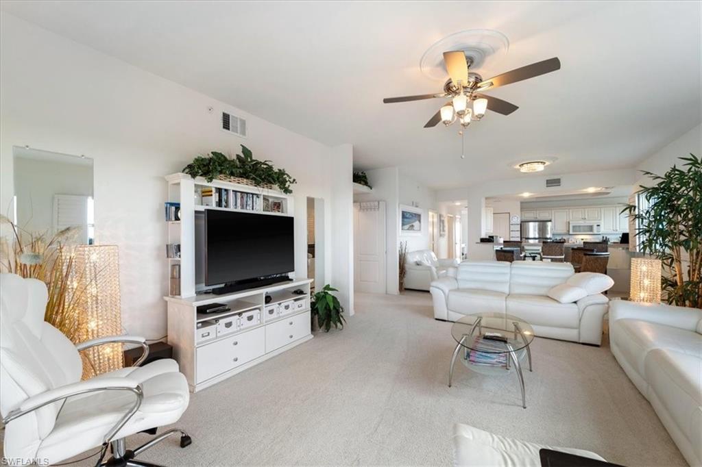 14819 Laguna Drive, Unit 501 Fort Myers, FL 33908 - Photo 11 of 48 a living room with furniture and a flat screen tv