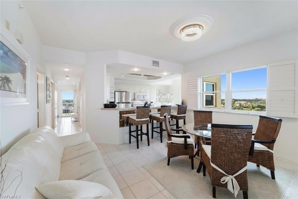 14819 Laguna Drive, Unit 501 Fort Myers, FL 33908 - Photo 13 of 48 a dining room with furniture and a view of kitchen