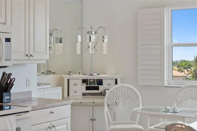 a bathroom with a granite countertop sink and a bathtub