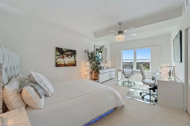 a living room with furniture a rug and a large window
