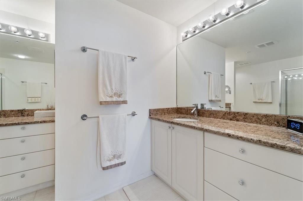 14819 Laguna Drive, Unit 501 Fort Myers, FL 33908 - Photo 28 of 48 a bathroom with a granite countertop sink and a mirror