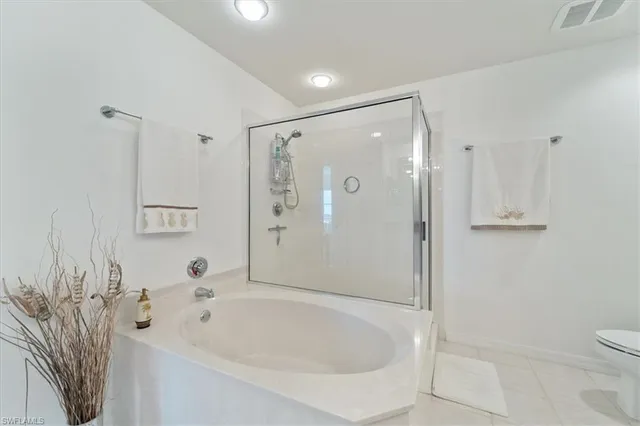 a bathroom with a bathtub a sink a vanity and a shower