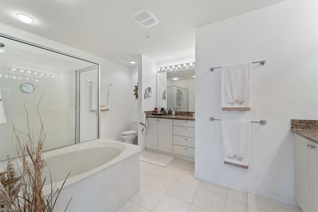 14819 Laguna Drive, Unit 501 Fort Myers, FL 33908 - Photo 31 of 48 a bathroom with a bathtub a sink a vanity and a shower