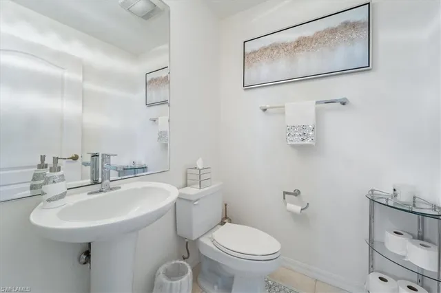 a bedroom with bed and a potted plant