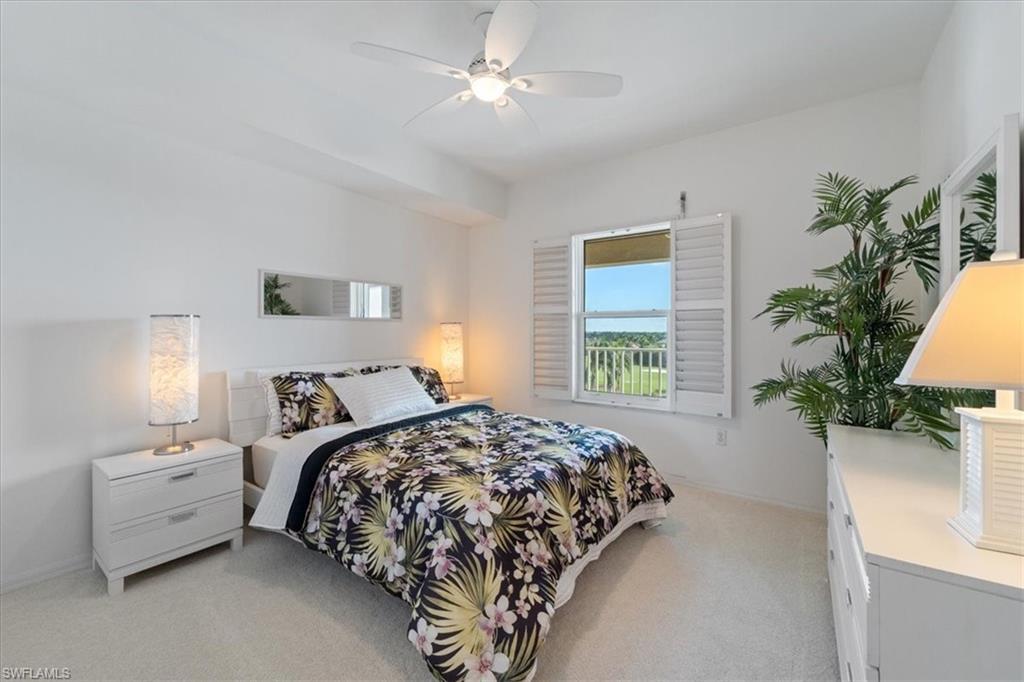 14819 Laguna Drive, Unit 501 Fort Myers, FL 33908 - Photo 33 of 48 a bedroom with bed and a potted plant