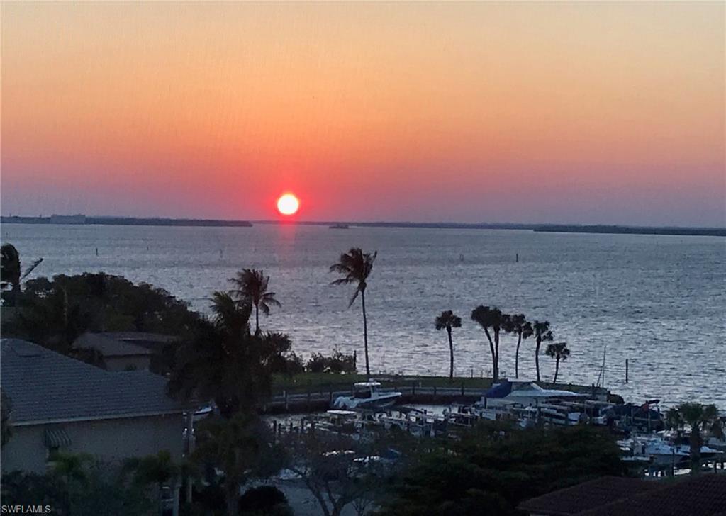 14819 Laguna Drive, Unit 501 Fort Myers, FL 33908 - Photo 5 of 48 a view of a lake with sunset