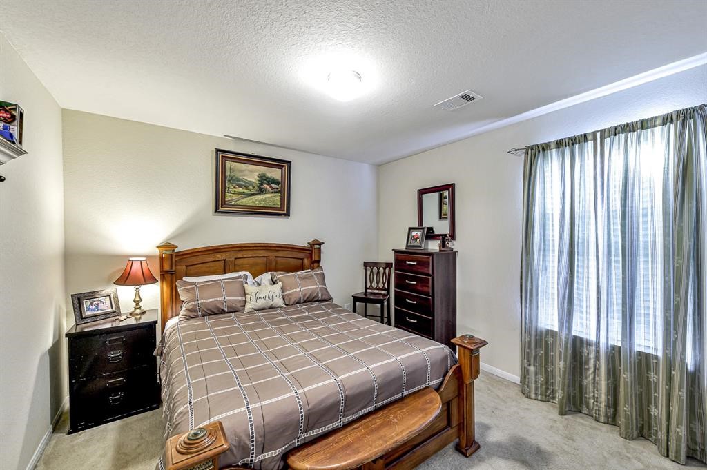 3203 Dale Ridge Trail Houston, TX 77084 - Photo 21 of 33 Cozy secondary bedroom featuring ample natural light, large windows, and a comfortable layout.