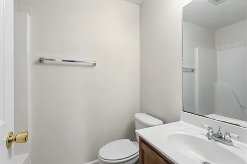 a bathroom with a sink toilet and mirror