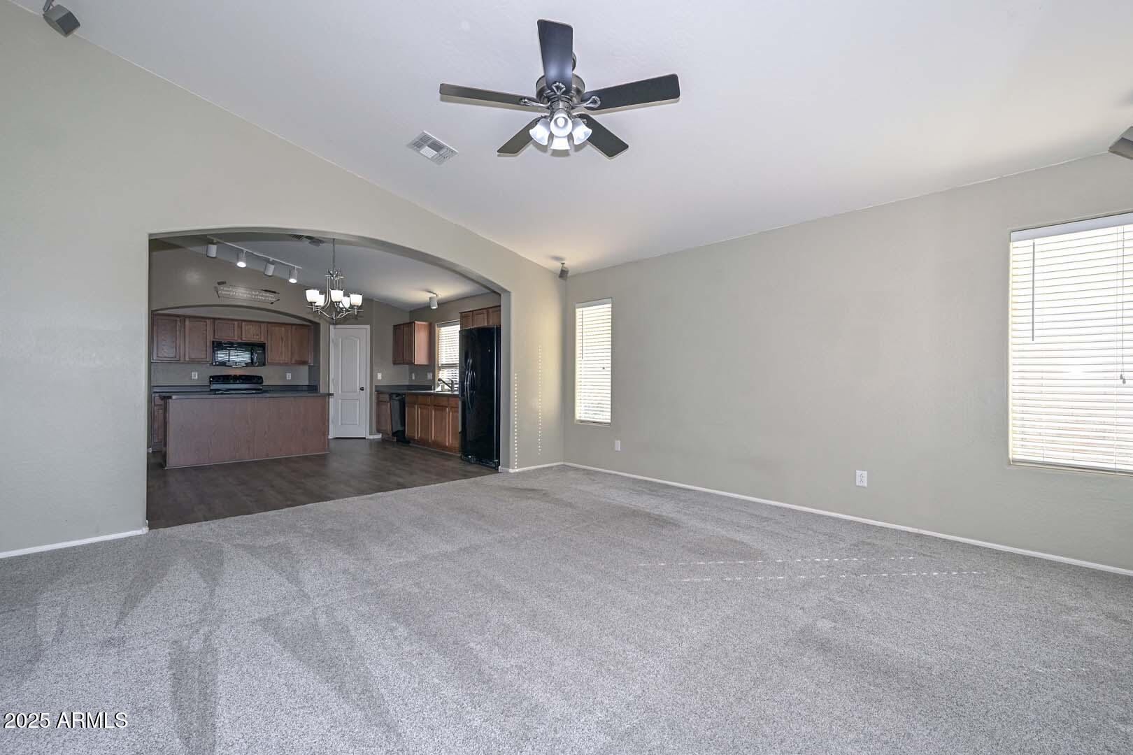 17687 West Charter Oak Road Surprise, AZ 85388 - Photo 18 of 52 a view of an empty room with a window and a kitchen