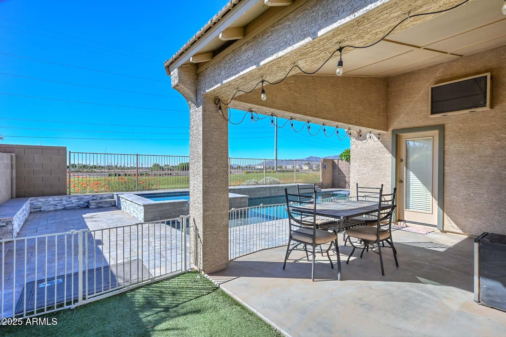 17687 West Charter Oak Road Surprise, AZ 85388 - Photo 34 of 52 a view of a patio with table and chairs under an umbrella