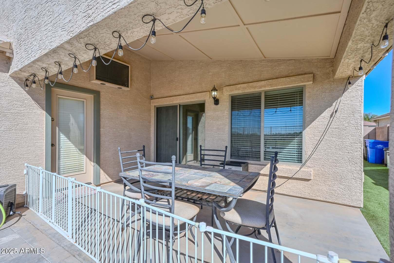 17687 West Charter Oak Road Surprise, AZ 85388 - Photo 35 of 52 a view of a patio with table and chairs with wooden floor and fence