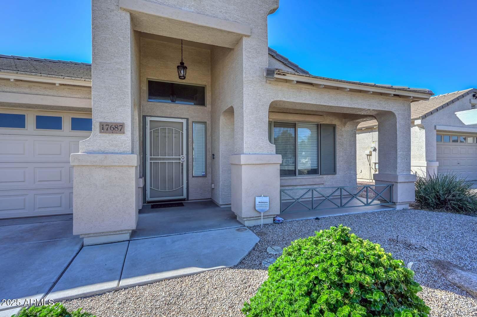 17687 West Charter Oak Road Surprise, AZ 85388 - Photo 4 of 52 front view of a house with a yard