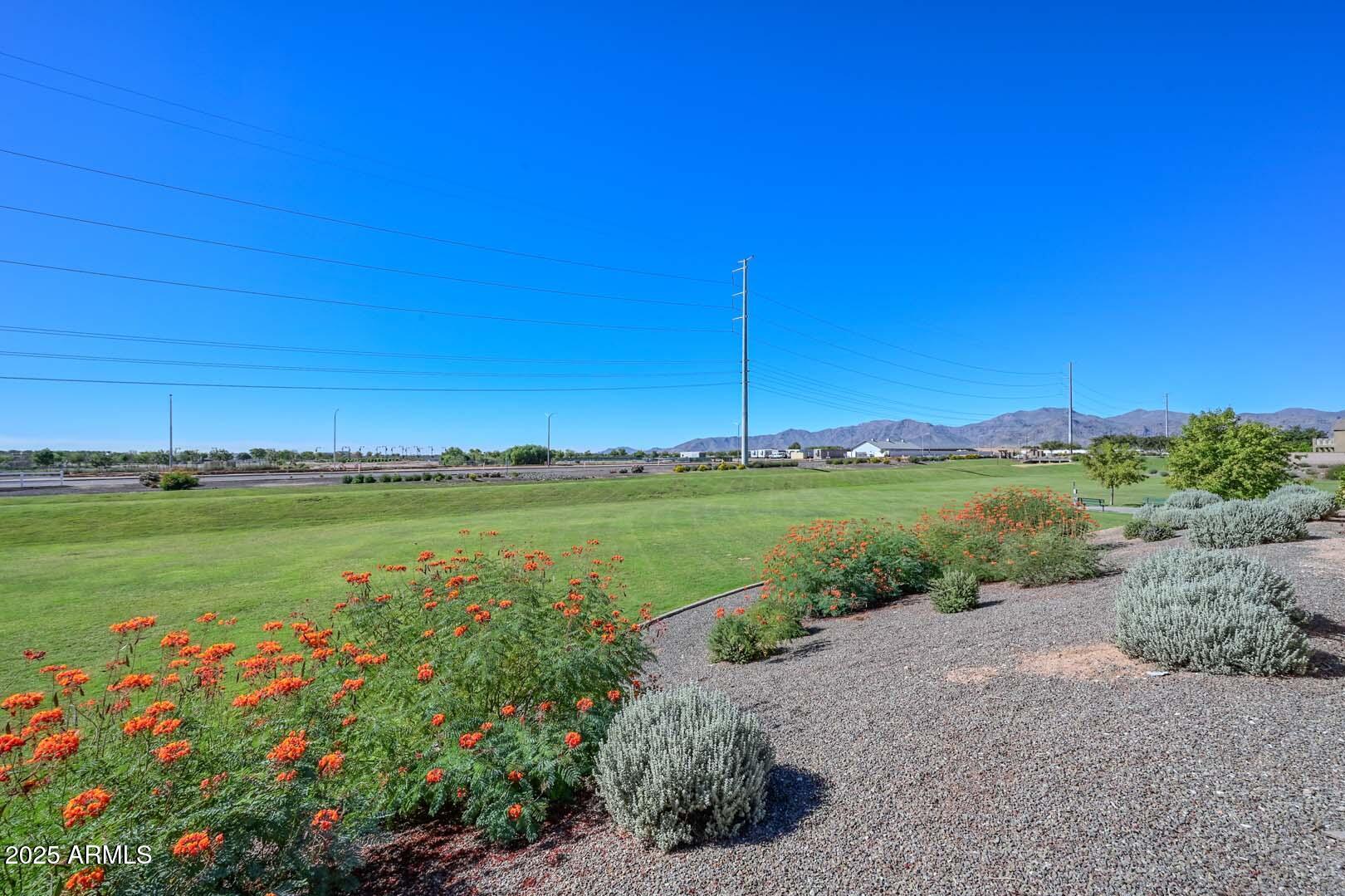 17687 West Charter Oak Road Surprise, AZ 85388 - Photo 45 of 52 a view of a lake with a house in the background