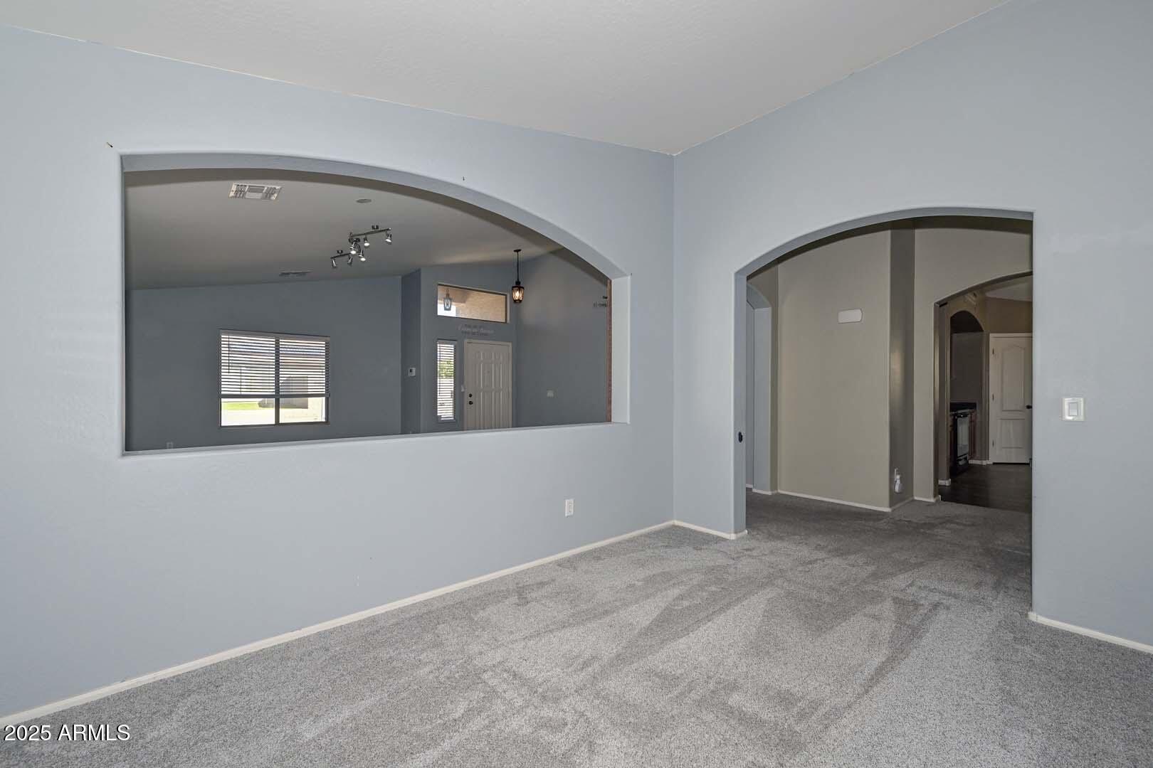 17687 West Charter Oak Road Surprise, AZ 85388 - Photo 9 of 52 a view of an empty room with wooden door