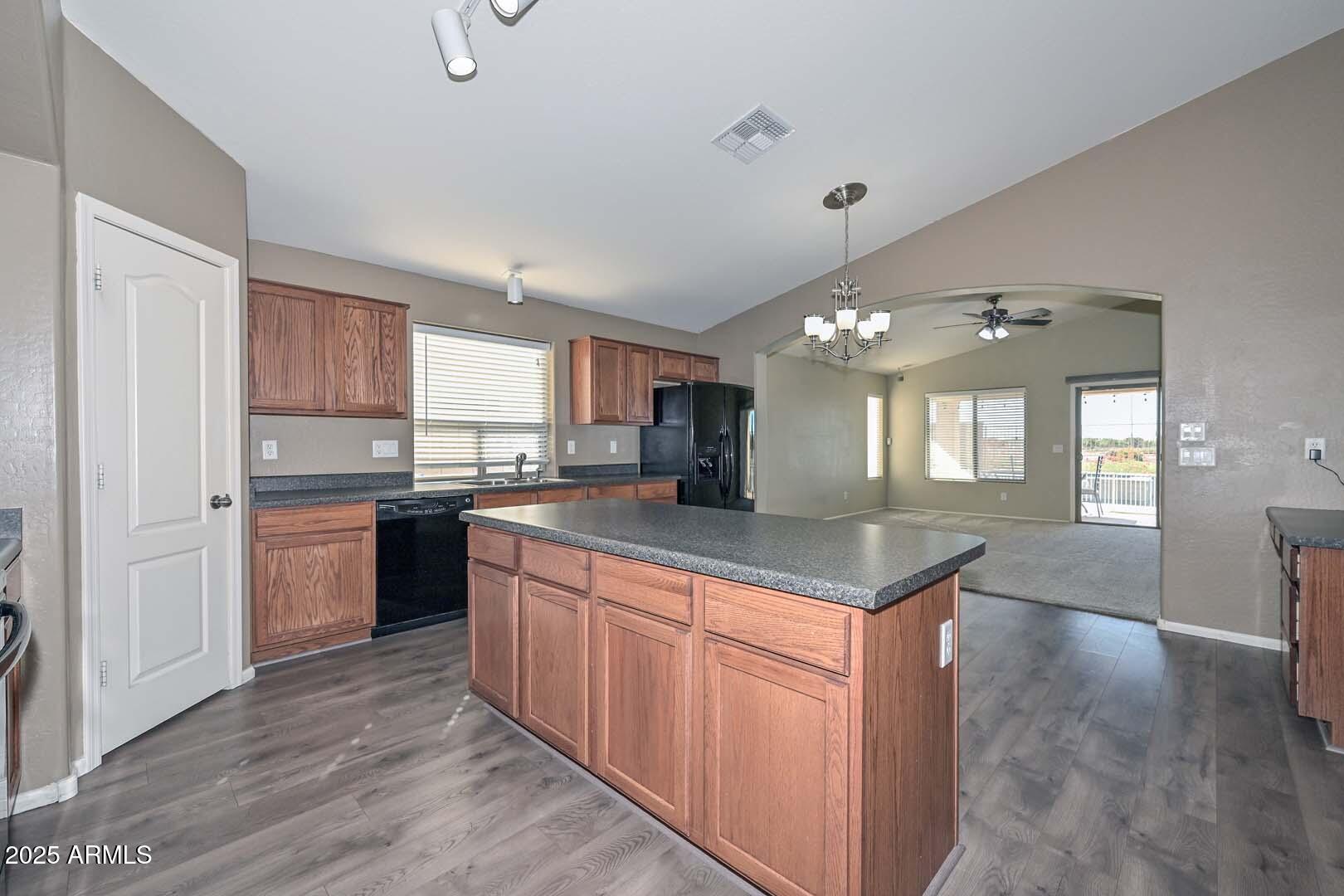 17687 West Charter Oak Road Surprise, AZ 85388 - Photo 10 of 52 a kitchen with stainless steel appliances granite countertop a sink a stove and a refrigerator