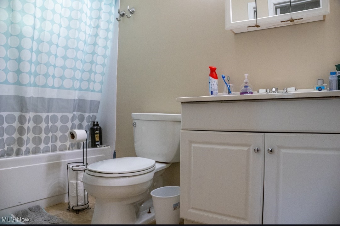 1770 Meadows Road Madison, OH 44057 - Photo 12 of 22 Full bath featuring vanity, shower / bathtub combination with curtain, and tile patterned flooring