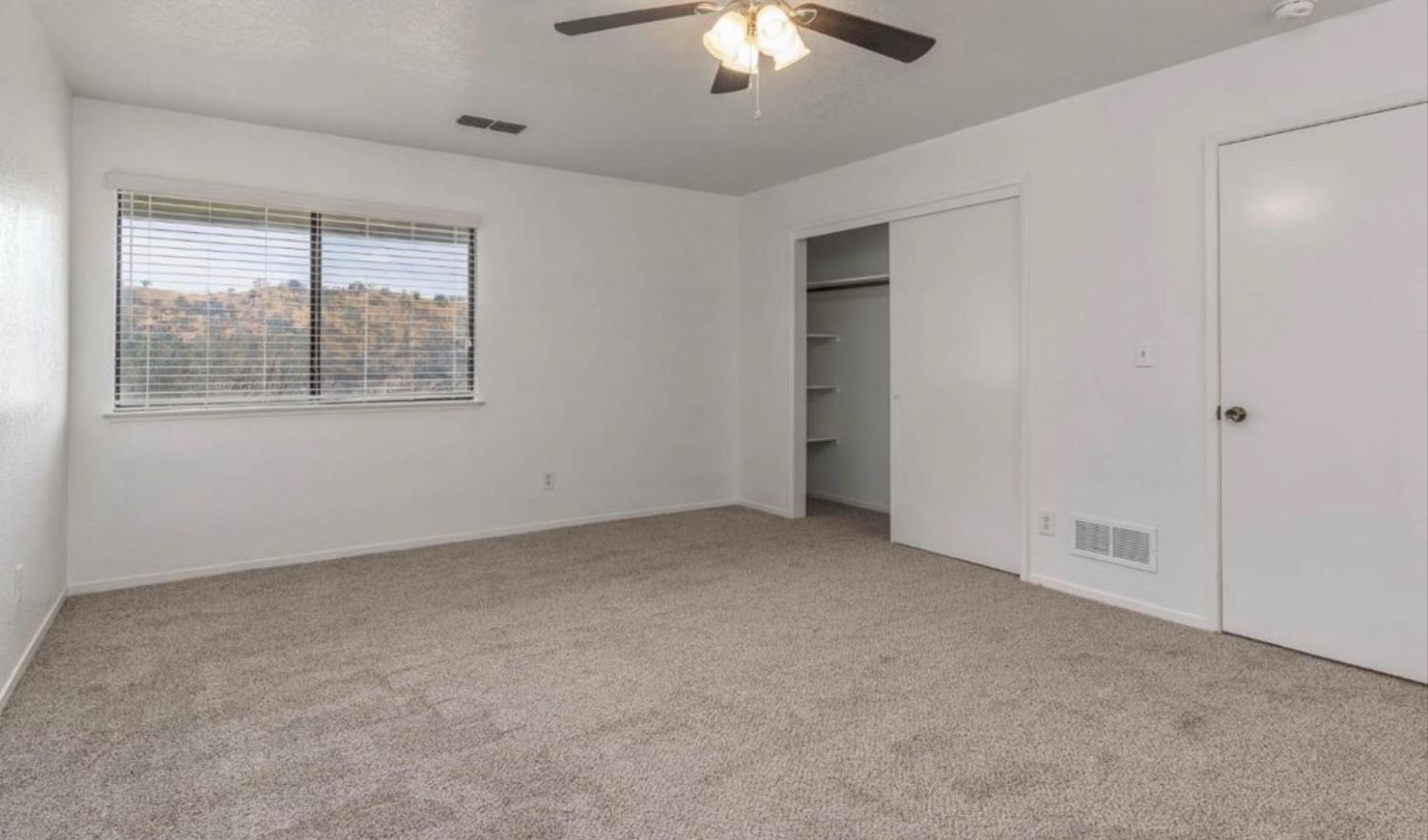 27817 Sky Harbour Road Friant, CA 93626 - Photo 20 of 36 an empty room with chandelier fan