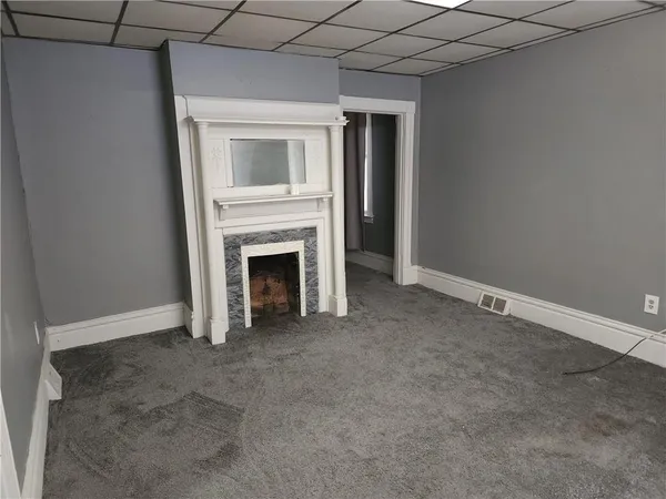 a view of empty room with a fireplace