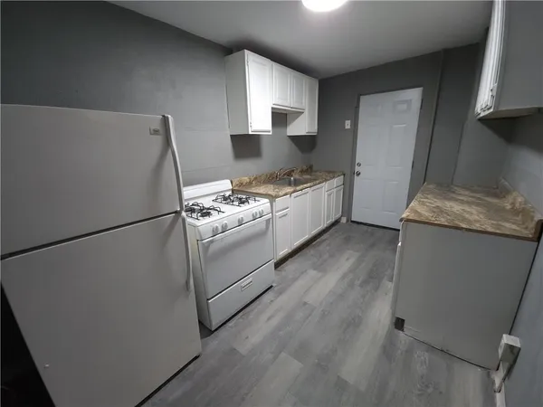 a kitchen with a refrigerator stove and sink