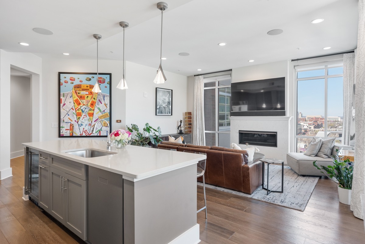 20 Rutledge Street, Unit 407 Nashville, TN 37210 - Photo 12 of 56 a living room with furniture a fireplace and a flat screen tv