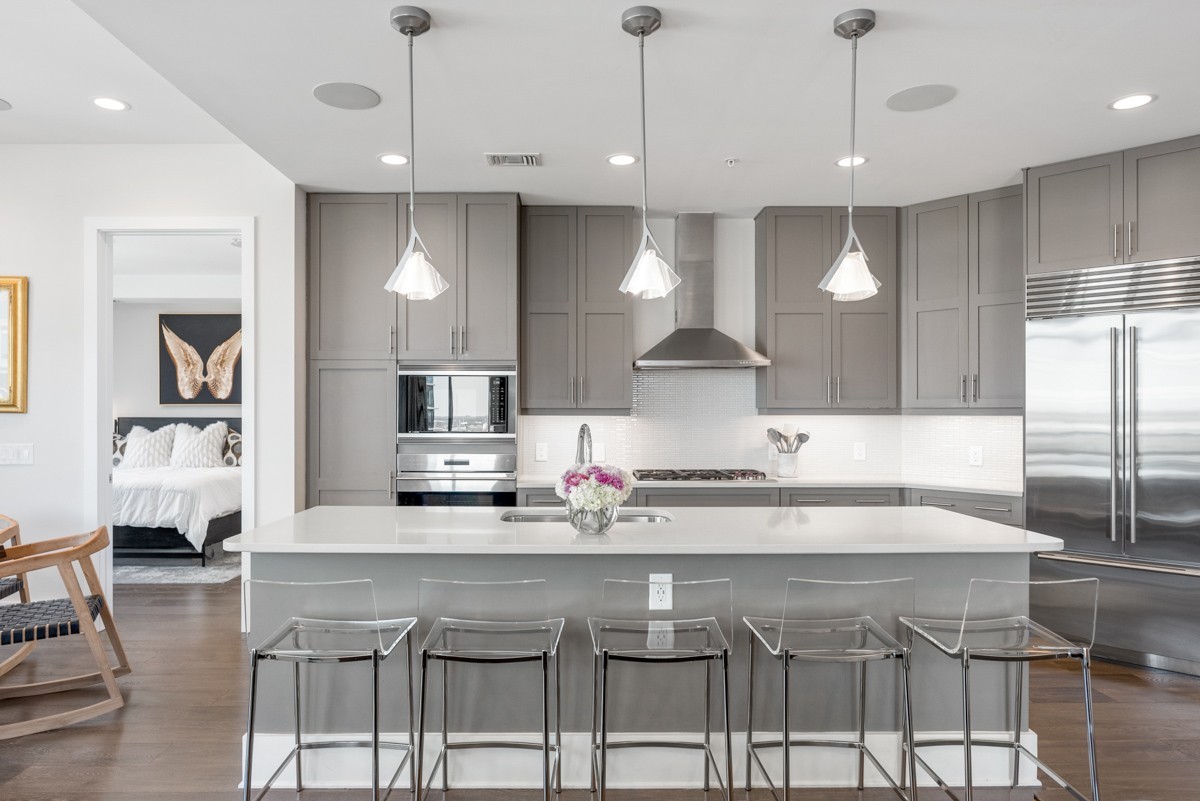 20 Rutledge Street, Unit 407 Nashville, TN 37210 - Photo 13 of 56 a kitchen with a table chairs refrigerator and microwave