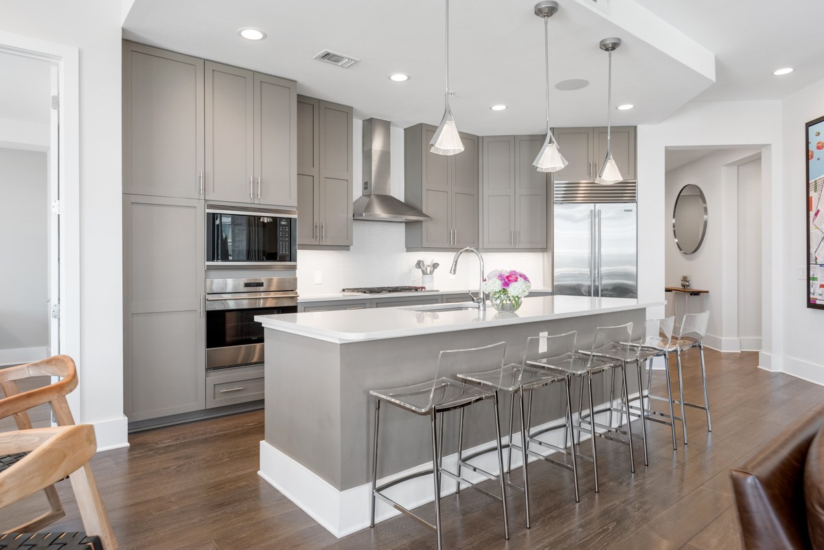 20 Rutledge Street, Unit 407 Nashville, TN 37210 - Photo 14 of 56 a kitchen with kitchen island granite countertop a sink a center island stainless steel appliances and cabinets