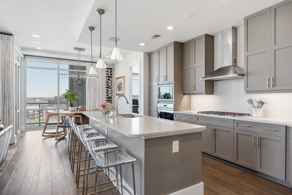 20 Rutledge Street, Unit 407 Nashville, TN 37210 - Photo 17 of 56 a large kitchen with stainless steel appliances a large center island attached withe living room