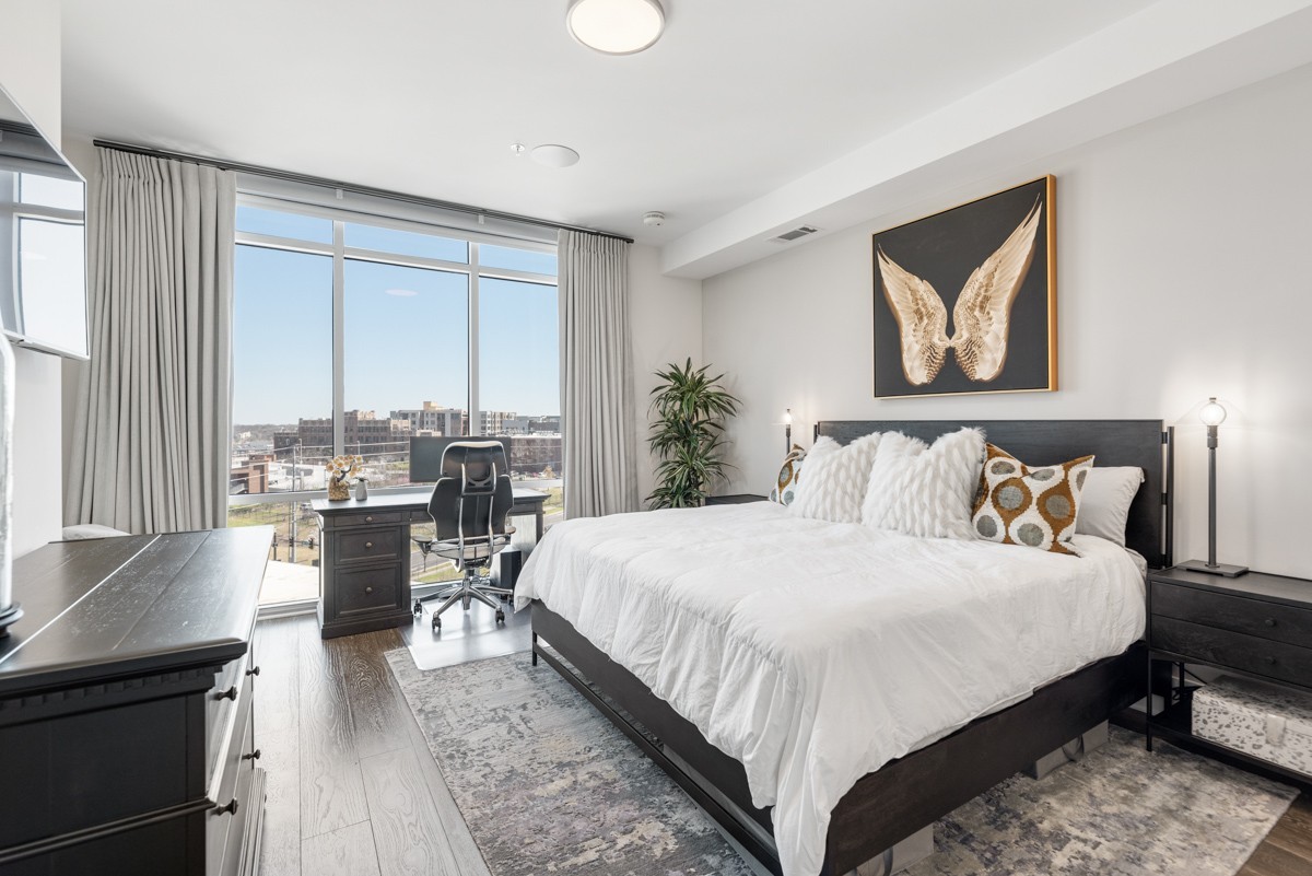 20 Rutledge Street, Unit 407 Nashville, TN 37210 - Photo 20 of 56 a bedroom with a large bed and a table chair