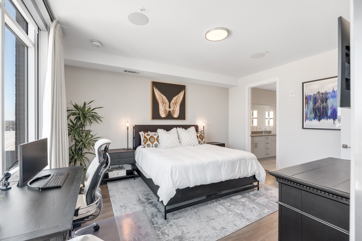 20 Rutledge Street, Unit 407 Nashville, TN 37210 - Photo 22 of 56 a bedroom with a bed a computer on desk and a dresser next to a window